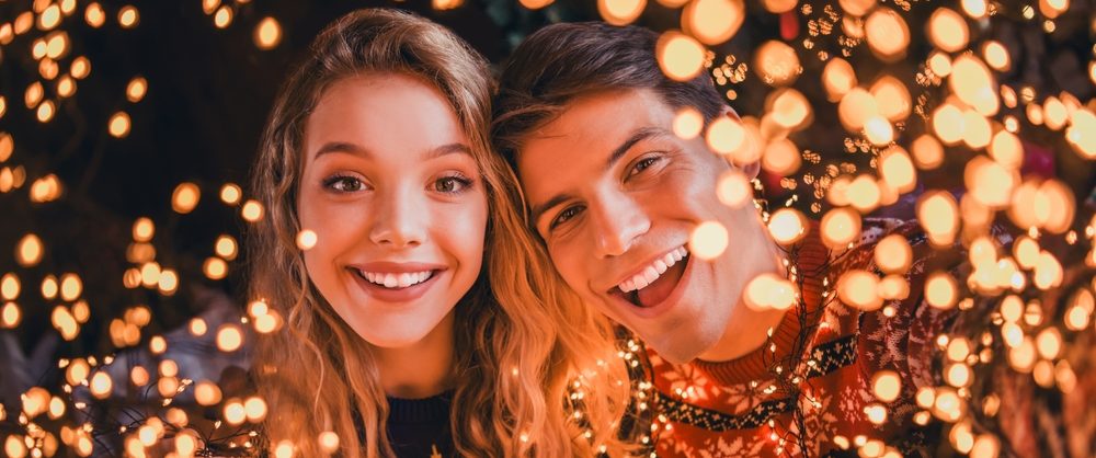 PhotoOfPrettyYoungCoupleCheerfulSmileCameraDressedChristmas - ASAP Cincinnati Celebrating a sober holiday season